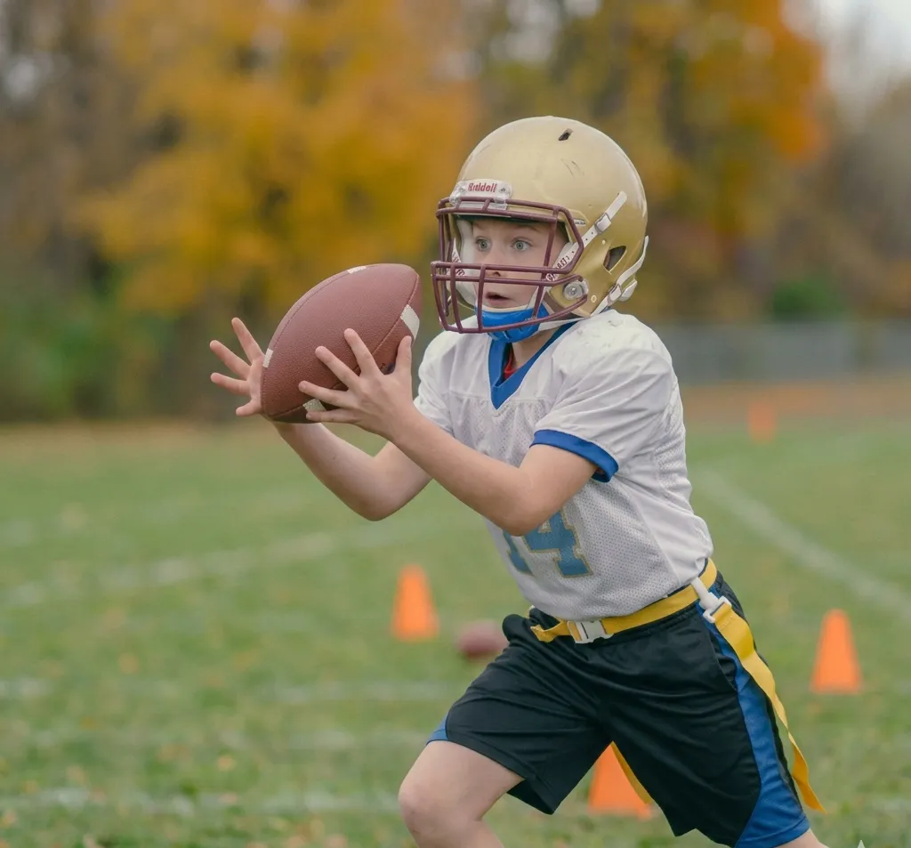 beginner player practicing hand catching football drill